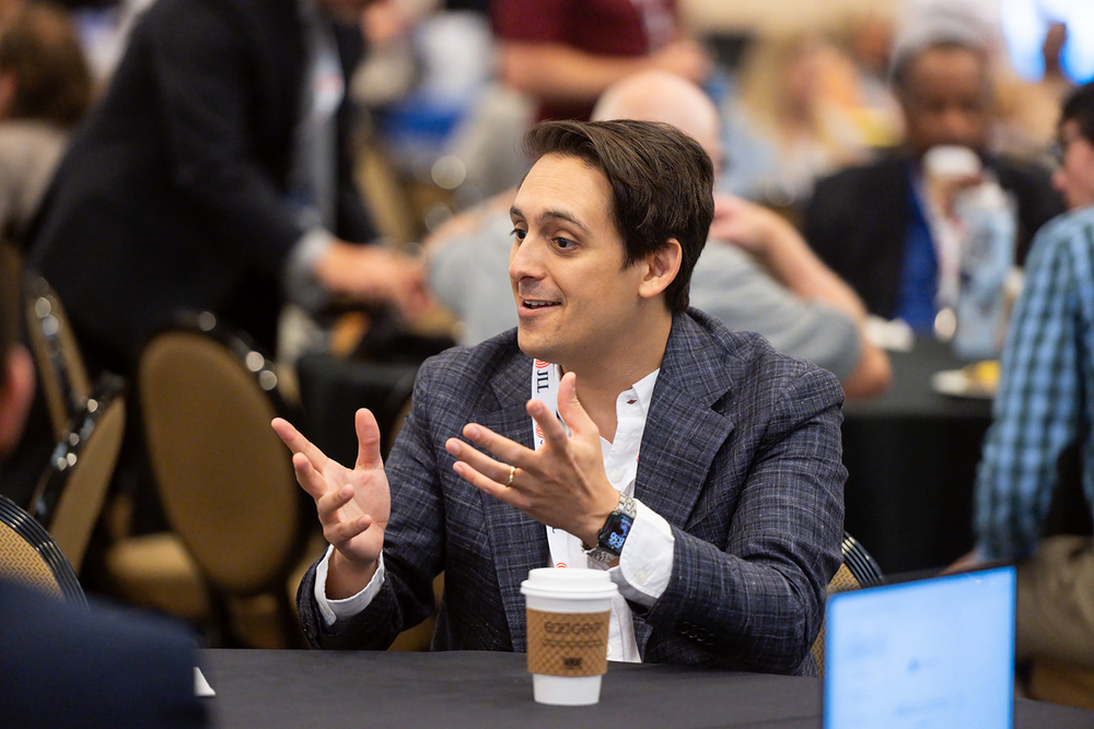 Attendee in conversation at the 2026 conference